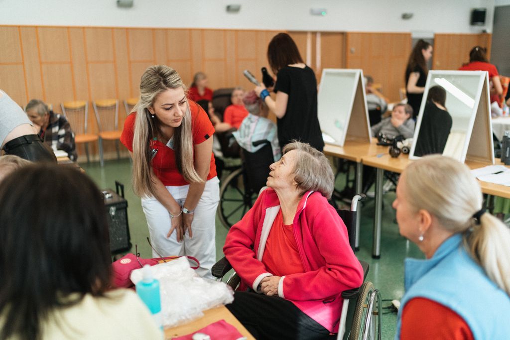Friendly interaction between caregivers and seniors in a care facility.